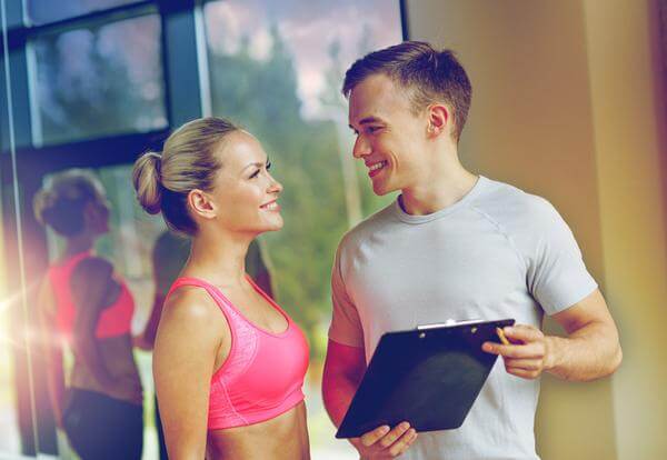 Personal trainer consulting with client